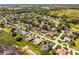 Beautiful aerial view of a neighborhood with lush landscaping and a large lake in the background and the house highlighted at 324 Hamilton Shores Ne Dr, Winter Haven, FL 33881