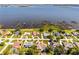 Aerial shot of a lakefront home in a residential neighborhood; docks provide lake access and the house is highlighted at 324 Hamilton Shores Ne Dr, Winter Haven, FL 33881