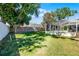 A fenced backyard with green grass and the home's screened-in pool at 324 Hamilton Shores Ne Dr, Winter Haven, FL 33881