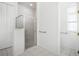 Bathroom featuring glass enclosed shower with grab bars and white tile floors at 324 Hamilton Shores Ne Dr, Winter Haven, FL 33881