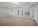 Spacious bedroom featuring neutral carpet, a ceiling fan, and lots of windows for natural light at 324 Hamilton Shores Ne Dr, Winter Haven, FL 33881