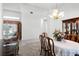 Dining room area with chandelier, a floral arrangement, and view to the living room at 324 Hamilton Shores Ne Dr, Winter Haven, FL 33881