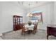 Formal dining room with an elegant chandelier, large windows and dark furniture at 324 Hamilton Shores Ne Dr, Winter Haven, FL 33881