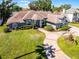 Inviting home exterior with a circular driveway and lush landscaping, perfect for curb appeal at 324 Hamilton Shores Ne Dr, Winter Haven, FL 33881