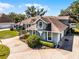 Two-story home with beautiful landscaping, a circular driveway, and a covered entry at 324 Hamilton Shores Ne Dr, Winter Haven, FL 33881