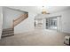 Open-concept living area with staircase, tile floors, and a view of the kitchen at 324 Hamilton Shores Ne Dr, Winter Haven, FL 33881