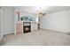 Bright living room featuring a fireplace, large windows and carpeted floors at 324 Hamilton Shores Ne Dr, Winter Haven, FL 33881