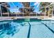 Inviting screened-in pool area with tiled accents and clear blue water at 324 Hamilton Shores Ne Dr, Winter Haven, FL 33881