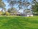 Expansive backyard features a covered patio and lush green lawn at 4570 Chambliss Rd, Winter Haven, FL 33884