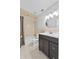 Bathroom featuring vanity with dark cabinets, tiled shower and floors, and modern lighting at 4570 Chambliss Rd, Winter Haven, FL 33884