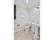 Half-bathroom featuring tile floors, pedestal sink, and modern fixtures at 4570 Chambliss Rd, Winter Haven, FL 33884