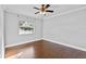 Well-lit bedroom showcasing a ceiling fan, window view, and hardwood floors at 4570 Chambliss Rd, Winter Haven, FL 33884