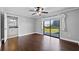 Bright bedroom featuring hardwood floors, ceiling fan, and sliding glass door to the backyard at 4570 Chambliss Rd, Winter Haven, FL 33884