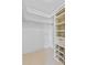 Walk-in closet with built-in shelving and hanging rods for ample storage at 4570 Chambliss Rd, Winter Haven, FL 33884