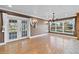 Bright dining room with glass doors, chandelier and hardwood floors at 4570 Chambliss Rd, Winter Haven, FL 33884