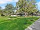 Well-manicured front yard with mature trees and lush lawn at 4570 Chambliss Rd, Winter Haven, FL 33884