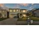 Two-story house exterior with gray siding, and a two-car garage at 935 Waterville Dr, Auburndale, FL 33823