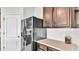 Kitchen area with black refrigerator and dark brown cabinets at 935 Waterville Dr, Auburndale, FL 33823