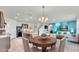 Virtually staged kitchen and dining area with an island and dark brown cabinets at 935 Waterville Dr, Auburndale, FL 33823