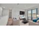 Virtually staged living room with two sofas, a coffee table, and large windows at 935 Waterville Dr, Auburndale, FL 33823