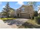 Two-story home with a two-car garage, stone accents, paved driveway and manicured front lawn at 137 Drayton Ave, Davenport, FL 33837