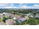 Scenic aerial view of a neighborhood featuring homes, mature trees, and lakes in the background at 1591 Forest Hills Ln, Haines City, FL 33844