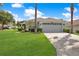 Charming single-story home featuring a well-manicured lawn and an attached two-car garage at 1591 Forest Hills Ln, Haines City, FL 33844