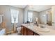 Bathroom features double vanity, neutral tile and a shower/tub combo at 2556 Ladoga Dr, Lakeland, FL 33805