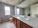 Double vanity bathroom with neutral tile and a shower/tub combo at 2556 Ladoga Dr, Lakeland, FL 33805