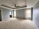 Large main bedroom with ceiling fan, neutral walls, and carpet flooring at 2556 Ladoga Dr, Lakeland, FL 33805