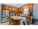 Kitchen features wood cabinets, stainless steel appliances, and an island with seating at 2556 Ladoga Dr, Lakeland, FL 33805