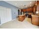 Kitchen with island, stainless steel appliances, and wood cabinets at 2556 Ladoga Dr, Lakeland, FL 33805