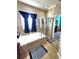 Elegant bathroom featuring a soaking tub, walk-in shower, and stylish blue accents at 2712 Oak Hammock Loop, Mulberry, FL 33860