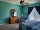 Inviting bedroom with a teal accent wall, natural light, and cozy furniture at 2712 Oak Hammock Loop, Mulberry, FL 33860
