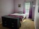 Bright bedroom with a purple wall, a ceiling fan, and a large window at 2712 Oak Hammock Loop, Mulberry, FL 33860