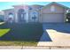 Charming single-story home with well-maintained lawn, inviting arched entrance, and a two-car garage at 2712 Oak Hammock Loop, Mulberry, FL 33860