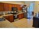Well-equipped kitchen with stainless steel appliances, wood cabinets, and granite countertops at 2712 Oak Hammock Loop, Mulberry, FL 33860