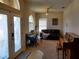 Bright living room features arched windows, a ceiling fan, and comfortable seating at 2712 Oak Hammock Loop, Mulberry, FL 33860