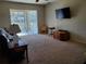 Relaxing living room with a comfortable couch, neutral carpet, and a sliding glass door at 2712 Oak Hammock Loop, Mulberry, FL 33860