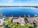 Breathtaking aerial view showcasing the home's lakefront location, pool, and private dock at 288 Hernando Rd, Winter Haven, FL 33884