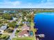 Aerial view of lakefront property showcasing the pool, dock, and community at 288 Hernando Rd, Winter Haven, FL 33884