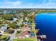 Aerial view of home on the lake showcasing a pool and dock with water access and neighborhood at 288 Hernando Rd, Winter Haven, FL 33884