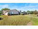 Well-maintained backyard with lush lawn, mature trees, and a screened-in pool area at 288 Hernando Rd, Winter Haven, FL 33884