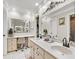 Well-lit bathroom with double sinks, vanity area, large mirror, and tile flooring at 288 Hernando Rd, Winter Haven, FL 33884