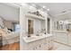 Dual vanity bathroom with a large mirror and access to the main bedroom at 288 Hernando Rd, Winter Haven, FL 33884