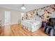 Bedroom showcasing a decorative wallpaper accent wall, and hardwood flooring at 288 Hernando Rd, Winter Haven, FL 33884