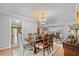 Elegant dining room featuring a chandelier, wood floors, and an open layout to the living areas at 288 Hernando Rd, Winter Haven, FL 33884