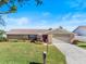 Charming single-story home with stone accents, lush landscaping, and a well-manicured lawn at 288 Hernando Rd, Winter Haven, FL 33884