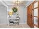 Welcoming foyer features a wooden front door, decorative table, and neutral color scheme at 288 Hernando Rd, Winter Haven, FL 33884