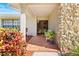 Inviting front porch with tiled flooring, stone accents, and decorative plants at 288 Hernando Rd, Winter Haven, FL 33884